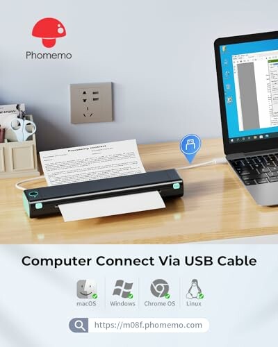 Portable scanner connected to a laptop via USB on a desk.